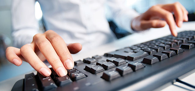 Closeup photo of hands on a keyboard