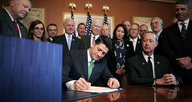 Republican House Speaker Paul Ryan signs the National Defense Authorization Act with members of the House Armed Services Committee, including Chairman Mac Thornberry, R-Texas, during an enrollment ceremony at the Capitol on Nov. 30. (Chip Somodevilla/Getty Images)