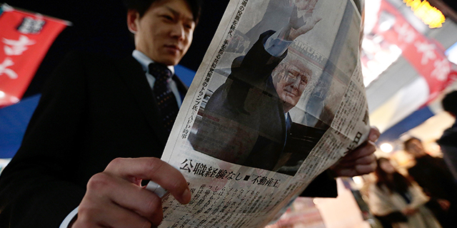 A man in Tokyo reads an extra edition of a newspaper featuring a report on the U.S. presidential election on Nov. 9, 2016. (Yuya Shino/Getty Images)