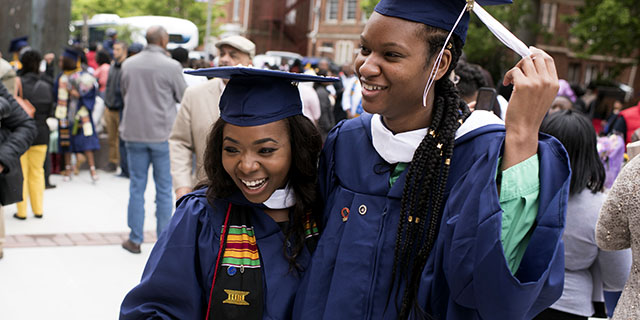 Angel C. Dye (left) celebrates her graduation from Howard University in Washington, D.C., with her friend Renee Walter on May 13, 2017. (Marvin Joseph/The Washington Post via Getty Images)