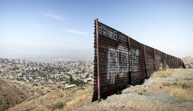 A gap in the fence near the U.S.-Mexico border overlooking Tijuana, Mexico, in 2014. (Photo by Charles Ommanney/Reportage by Getty Images)