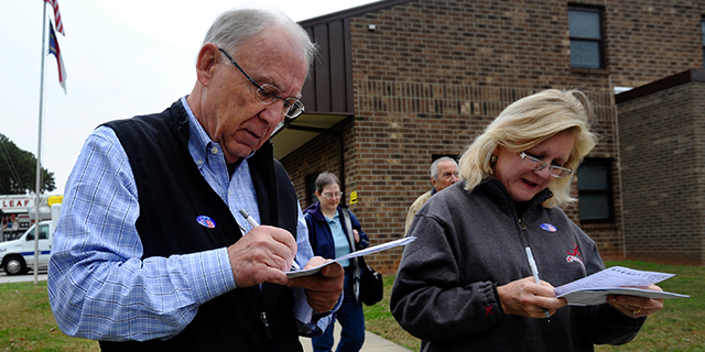 Terry and Mary Ann Williams fill out exit polls conducted by Edison Research after voting at the Bayleaf Volunteer Fire Department on November 6, 2012 in Raleigh, North Carolina. Photo by Sara D. Davis/Getty Images