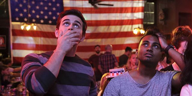 Supporters of presidential candidate Hillary Clinton watch televised coverage of the U.S. presidential election at Comet Tavern in the Capitol Hill neighborhood of Seattle on Nov. 8, 2016. (Photo by Jason Redmond/AFP/Getty Images)