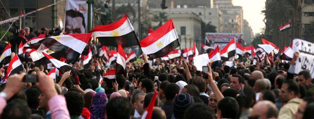 Cairo, Egypt - February 12, 2011: Egyptians take to Tahrir Sqaure in Cairo to celebrate the Egyptian revolution. Hosni Mubarak stepped down as the president of Egypt on after more than 20 million Egyptians showed their rejection of Mubarak in the streets of Egypt and around his presidential palace./ iStockphoto